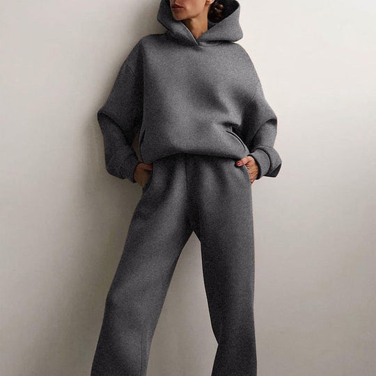Vrouw draagt een oversized hoodie en joggingbroek voor een moeiteloze look.