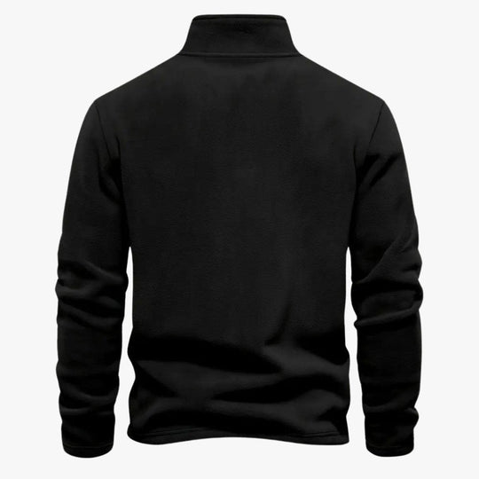 Blauwe sweater met elastische manchetten en zoom in focus.
